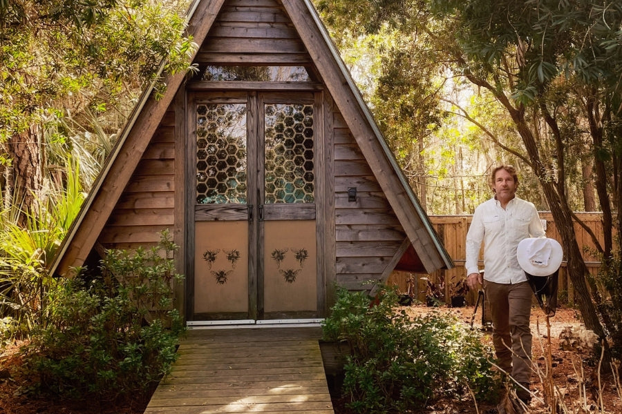 Ted walking outside of his sunlit therapy hut